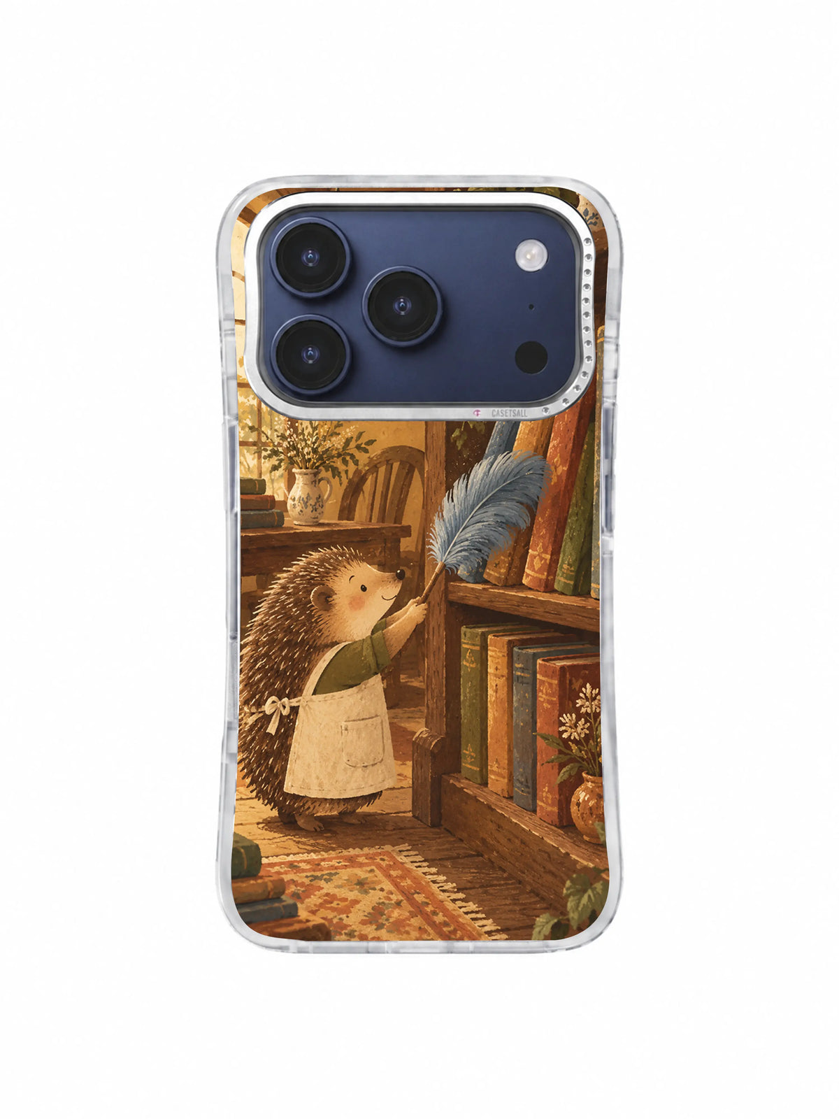 Hedgehog dusting a warm cottage library corner with a blue feather on an iPhone 17 Pro case