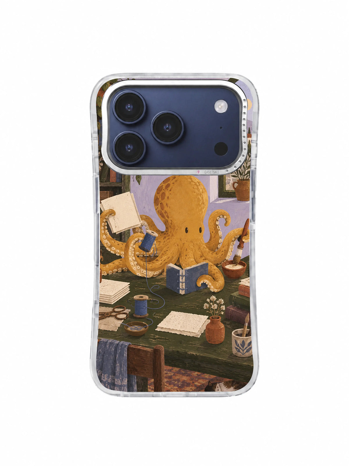Octopus surrounded by bookbinding tools on a dark olive table on an iPhone 17 Pro case