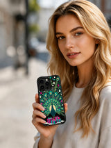 Person holding an Emerald Feather Noel black-edge iPhone 15 Pro case with peacock and Christmas gift artwork