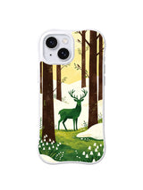Emerald stag between dark tree trunks and melting snow on an iPhone 13 case