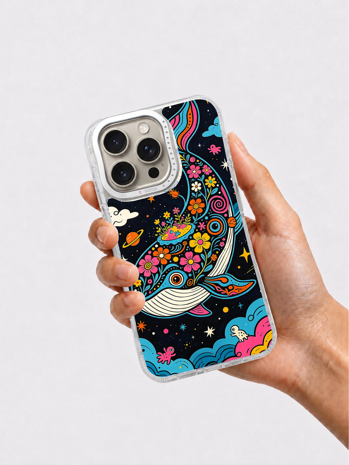 Colorful celestial whale phone case held in hand