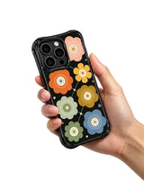 Eternal Floral Geometry iPhone 15 Pro case held in hand