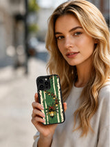 Lifestyle view of a person holding the Evergreen Lantern Path iPhone 14 Pro case