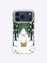 Frostwing Orchard iPhone 17 Pro Max case showing two rabbits pushing a fruit cart along a snowy orchard path