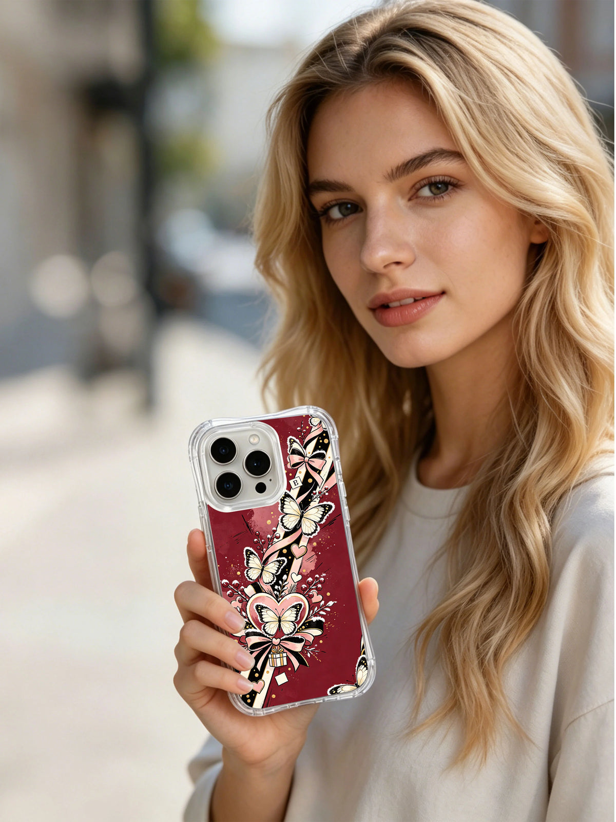 Frostwing Ribbon Hearts iPhone 14 Pro case held in a lifestyle scene