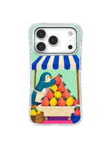 Coral pear and yellow lemon pyramid on a cream market stall on an iPhone 17 Pro case