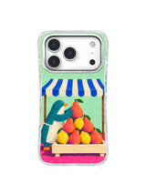 Teal penguin arranging coral pears and yellow lemons on an iPhone 17 Pro case