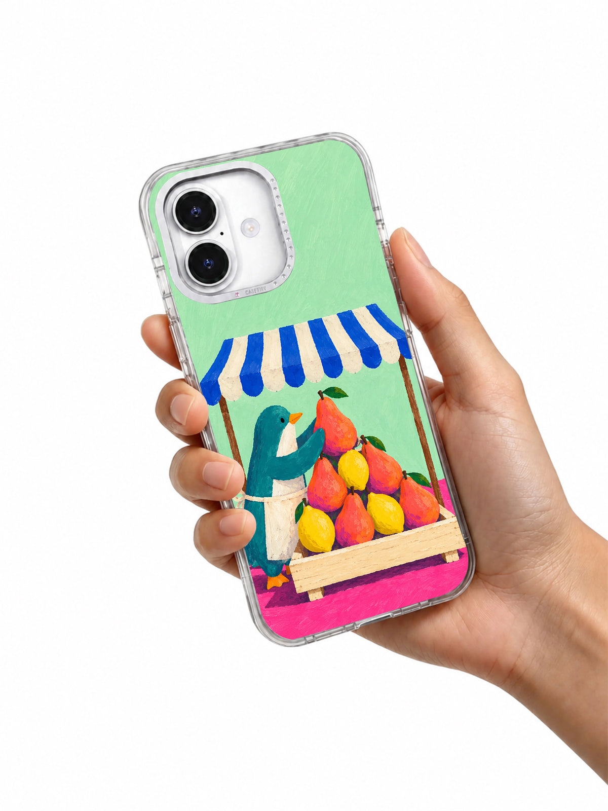 Hand holding a transparent iPhone 17 Pro case with the colorful fruit pyramid artwork