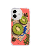 Kiwi and blue gecko iPhone 16 case artwork arranged across a pale stone on coral pink