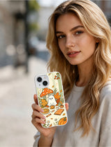 Woman holding the Ghost Tea Time in the Woods iPhone 14 case
