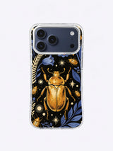 Large ochre beetle framed by indigo leaves, fern stems, small insects, and ivory star marks