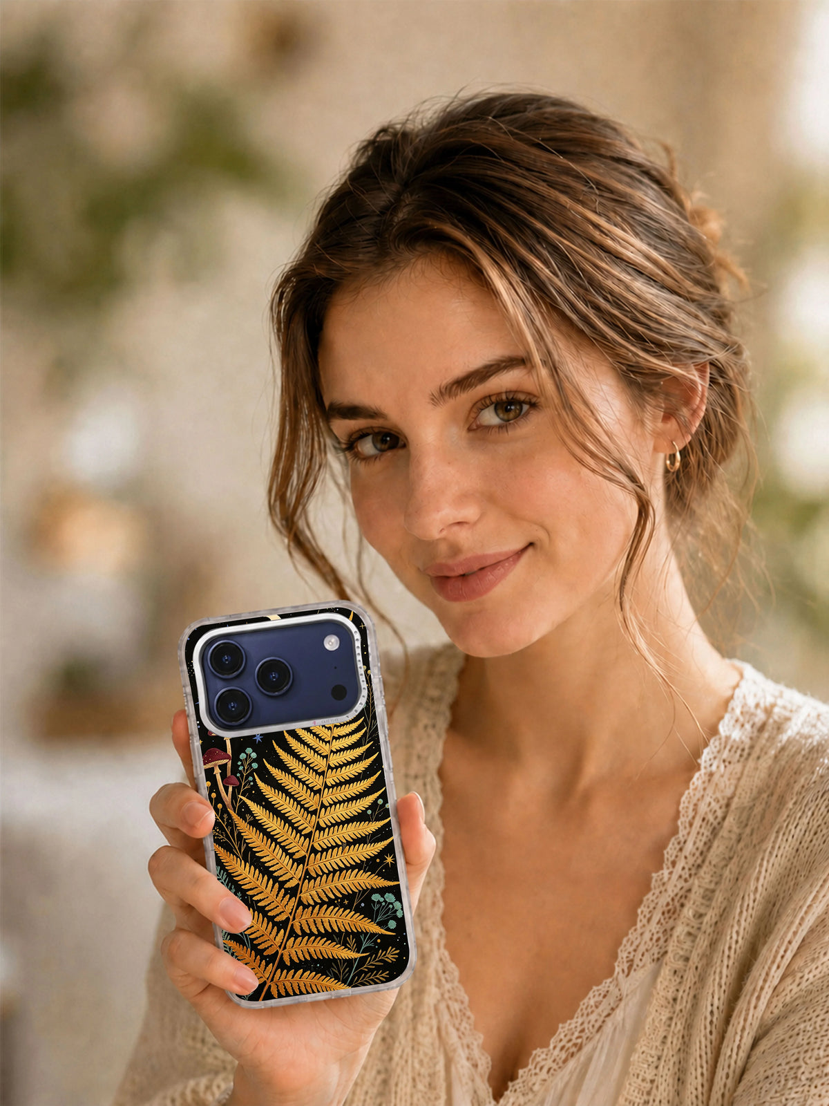 Lifestyle view of Golden Fern Constellation iPhone case with celestial fern artwork
