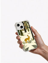 Hand-held lifestyle view of the Golden Hare Grove iPhone 13 case with mustard rabbit and winter forest art