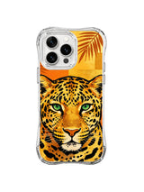 Close-up golden leopard face with green eyes and burnt-orange foliage on iPhone 13 Pro Max case