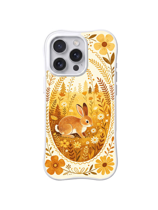 Golden Meadow Rabbit: A brown rabbit inside a golden oval meadow framed by tall stems and yellow flowers.