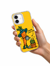 Hand holding an iPhone 16 case with Growing Is Not a Race carrot and cactus artwork