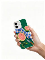 Guava Picnic Fold iPhone 16 case held in hand