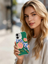 Lifestyle view of the Guava Picnic Fold iPhone 16 case