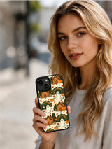 Woman holding the Haunted Cozy Cottage iPhone 14 case