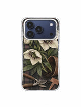 Open hellebore and terracotta marker on dark plaid iPhone 17 Pro case pattern three