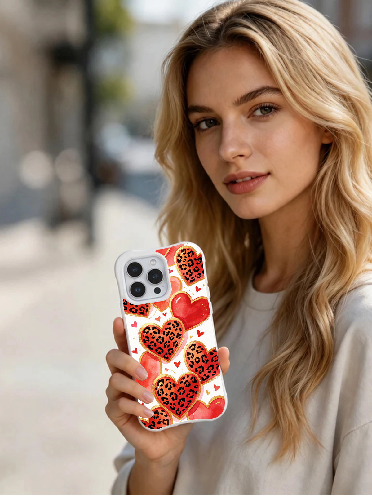 Honey Leopard Hearts illustrated phone case in hand