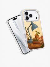 Angled front and back views of a clear iPhone 17 Pro case with lamp and seedling art