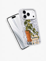 Angled front and back views of a clear iPhone 17 Pro case with plant reading artwork