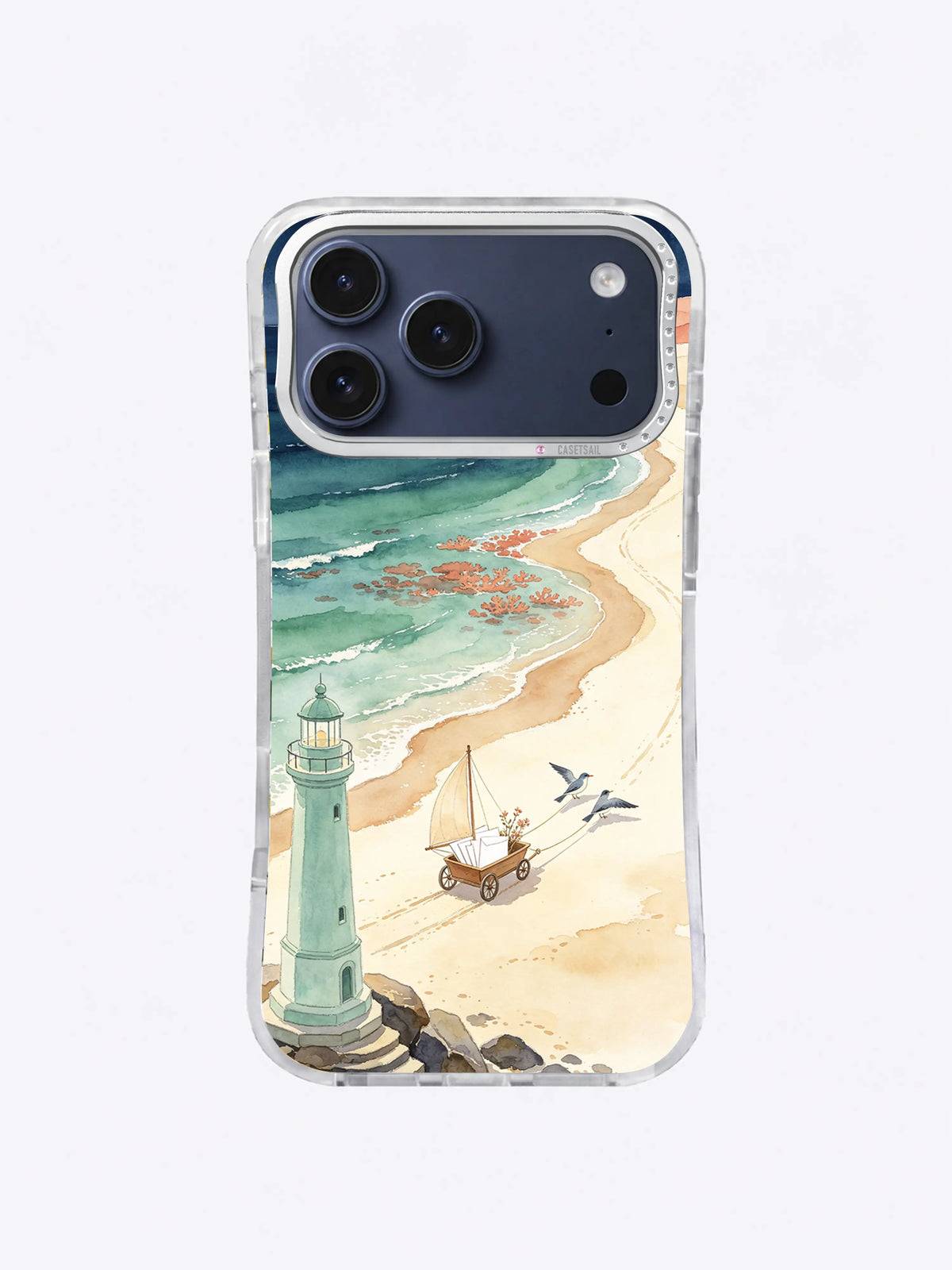 Homeward Winter Bay artwork on an iPhone 17 Pro Max case with a seafoam lighthouse, coral tide pools, and sandy paths
