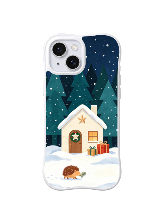 Little hedgehog crossing snow beside a cream Christmas cottage iPhone 14 case, pattern one
