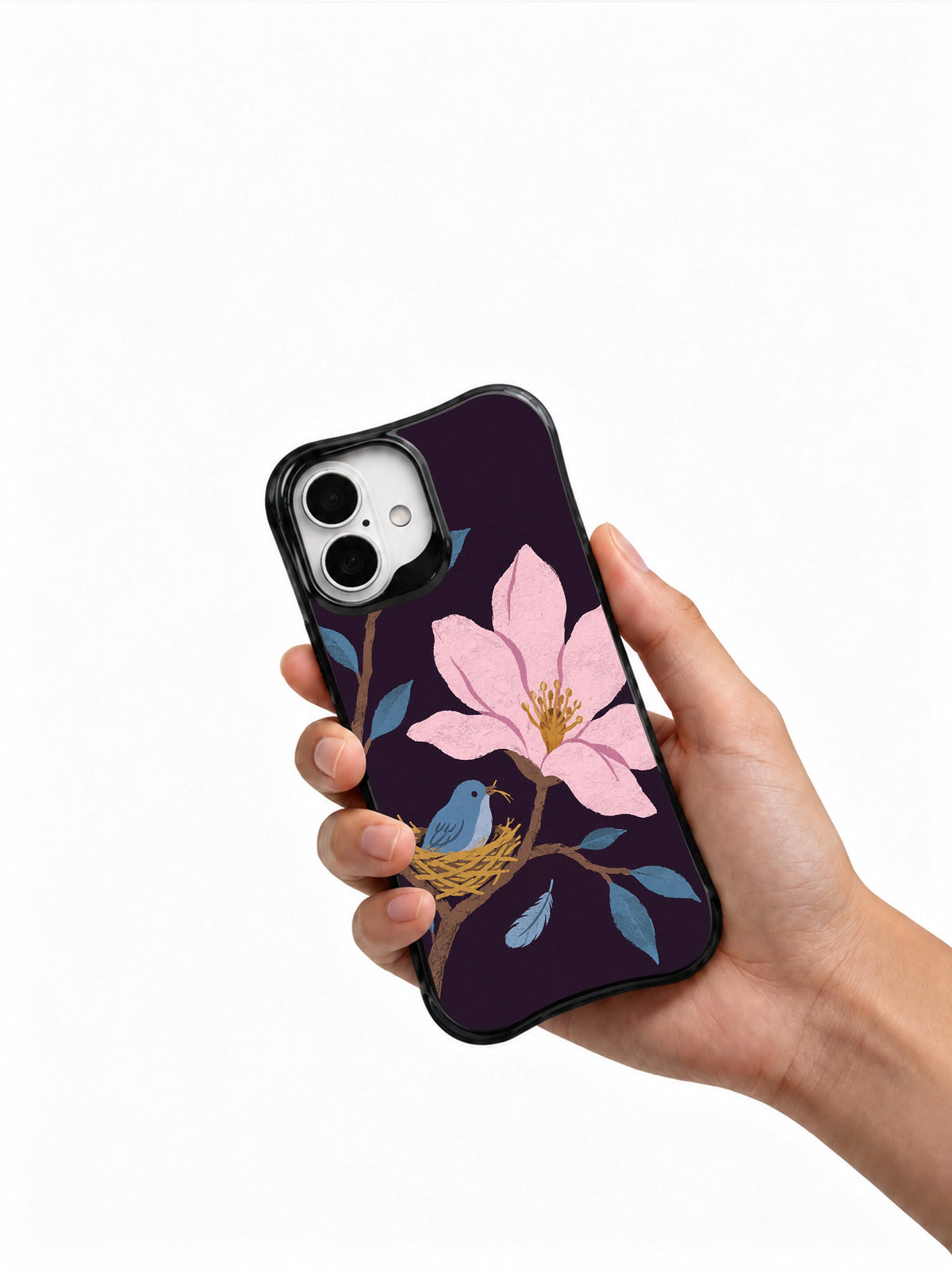 Hand holding a black iPhone 16 case with magnolia and bird artwork