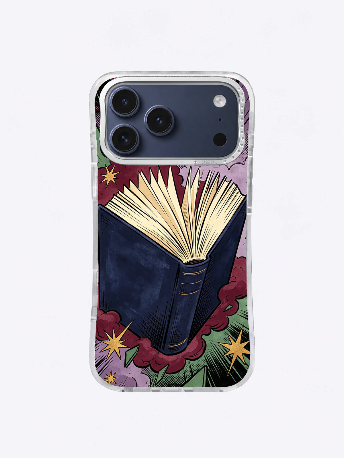 Open book pop-art iPhone case with navy cover, cream pages, burgundy impact cloud, forest-green rays, lavender grain, and gold stars