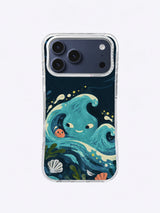 Turquoise wave creature with mismatched eyes beside a coral pebble on an iPhone 17 Pro Max case