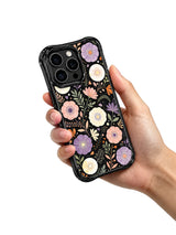 Moon Garden Fragments iPhone 15 Pro case in hand