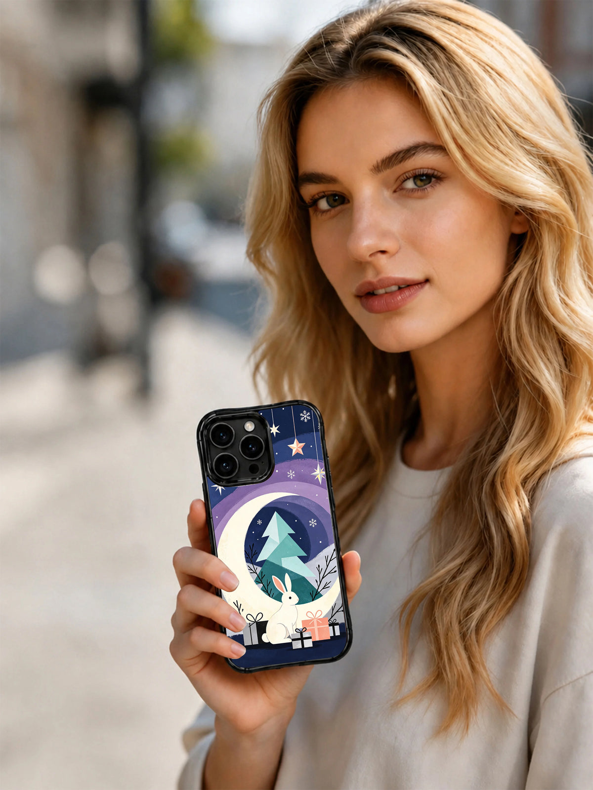 Lifestyle view of the Moon Rabbit ornament iPhone 15 Pro case held outdoors