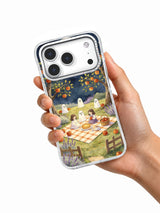 Moonlit Picnic in the Ghost Orchard iPhone case shown in hand