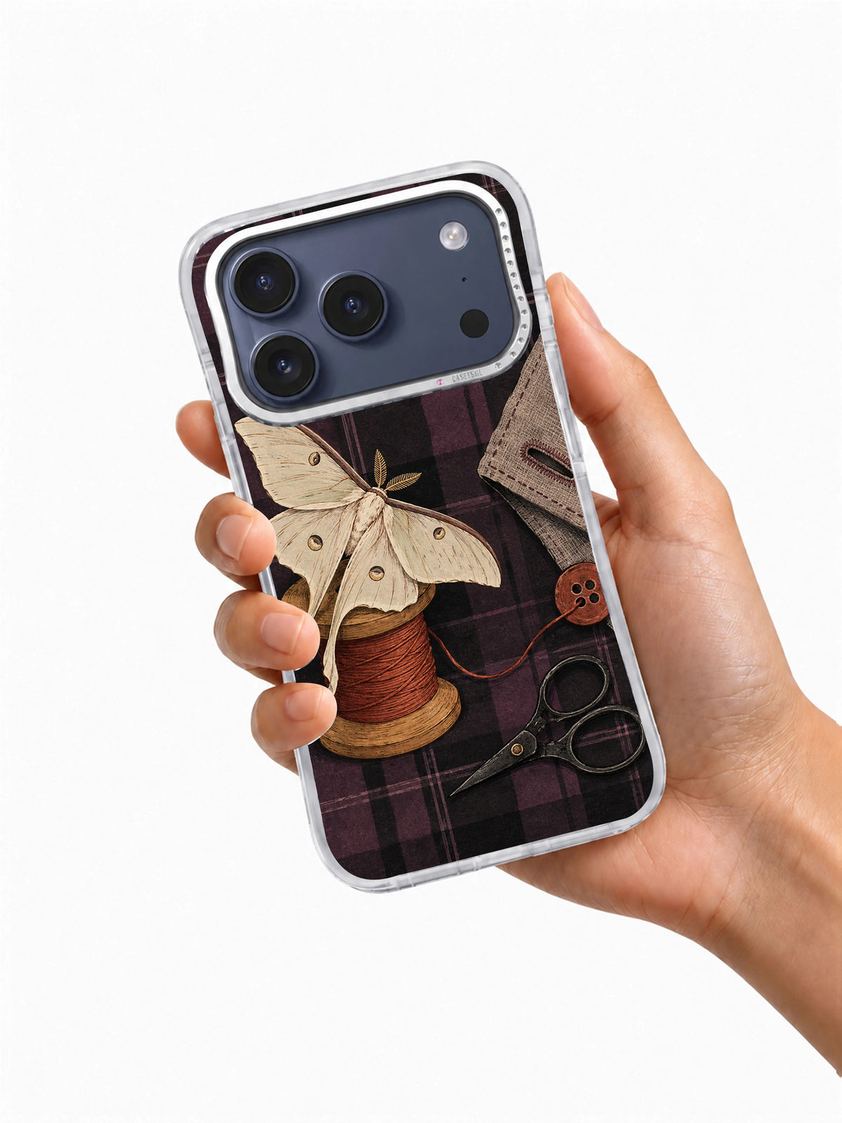 Moth at the Missing Button iPhone 17 Pro Case shown in hand