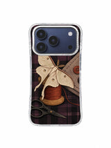 Moth at the Missing Button iPhone 17 Pro Case pattern 4 with moth, thread spool, button and black plum plaid