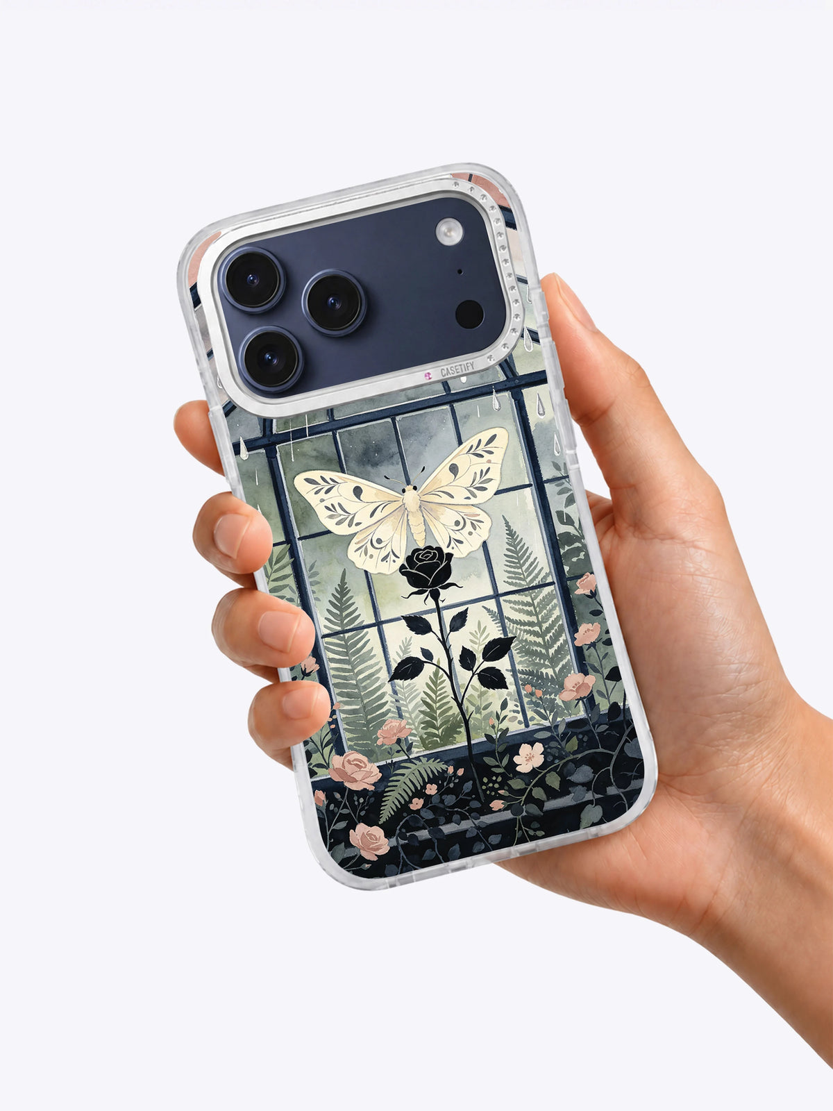 Hand holding The Moth Conservatory iPhone case