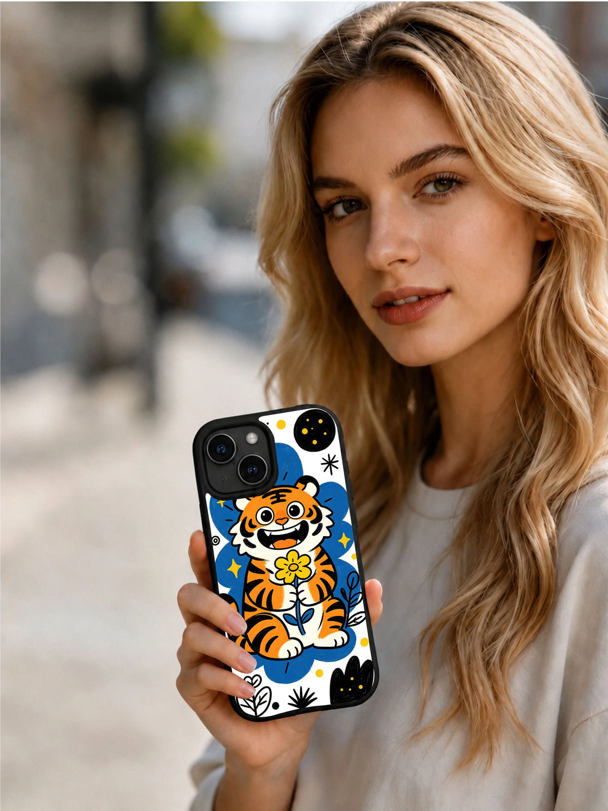 Lifestyle view of a woman holding the Night Bloom Tiger iPhone 13 case