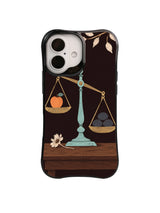 Apricot Worth balance scale artwork on a black iPhone case