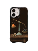 Beyond Comparison apricot and tilted scale artwork on a black iPhone case