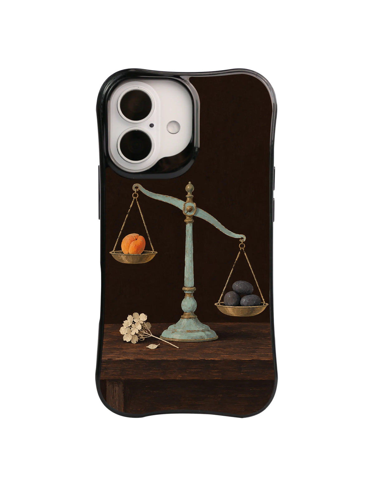 Ivory Reminder flower beside an old balance scale on a black iPhone case