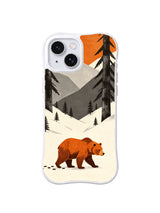 Burnt-orange bear following a dark track across an ivory winter valley on an iPhone 13 case
