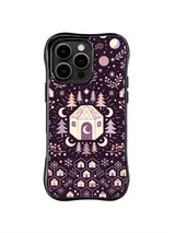 Orbital Winter Village pattern on a black iPhone 13 Pro case with circular planets, a faceted cottage, pines and a row of tiny houses