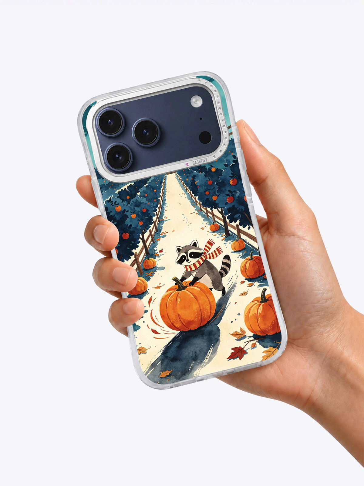 Hand holding Orchard of Midnight Pumpkins iPhone case