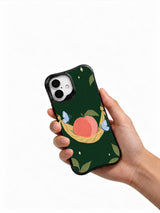 Hand holding a black iPhone 16 case with peach and butterfly artwork