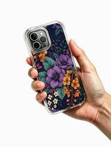 PhoneCasing iPhone 16 Pro Max Case with an aesthetic dark floral bouquet design. Deep blue background with purple and gold flowers, slim protective case.