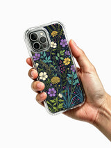 PhoneCasing iPhone 16 Pro Max Case with an aesthetic forest meadow design. Deep blue background with colorful wildflowers, slim protective case.