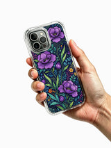 PhoneCasing iPhone 16 Pro Max Case with an aesthetic indigo peony design. Deep blue background with vibrant purple flowers, slim protective case.