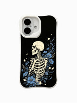 PhoneCasing Blue Bloom Night Voyage fine art iPhone 16 Case, original Morrigan Vale traditional old-school goth tattoo artwork with side-profile skeleton surrounded by flowing ocean-blue wildflowers and drifting petals against distressed solid black backdrop, scratch resistant glossy casing crafted in California